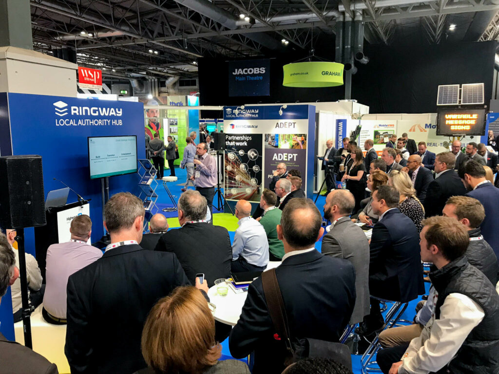 Picture of a full audience listening to an engaging presentation at the Ringway Local Authority Hub, part of the Highways UK exhibition in 2019.
